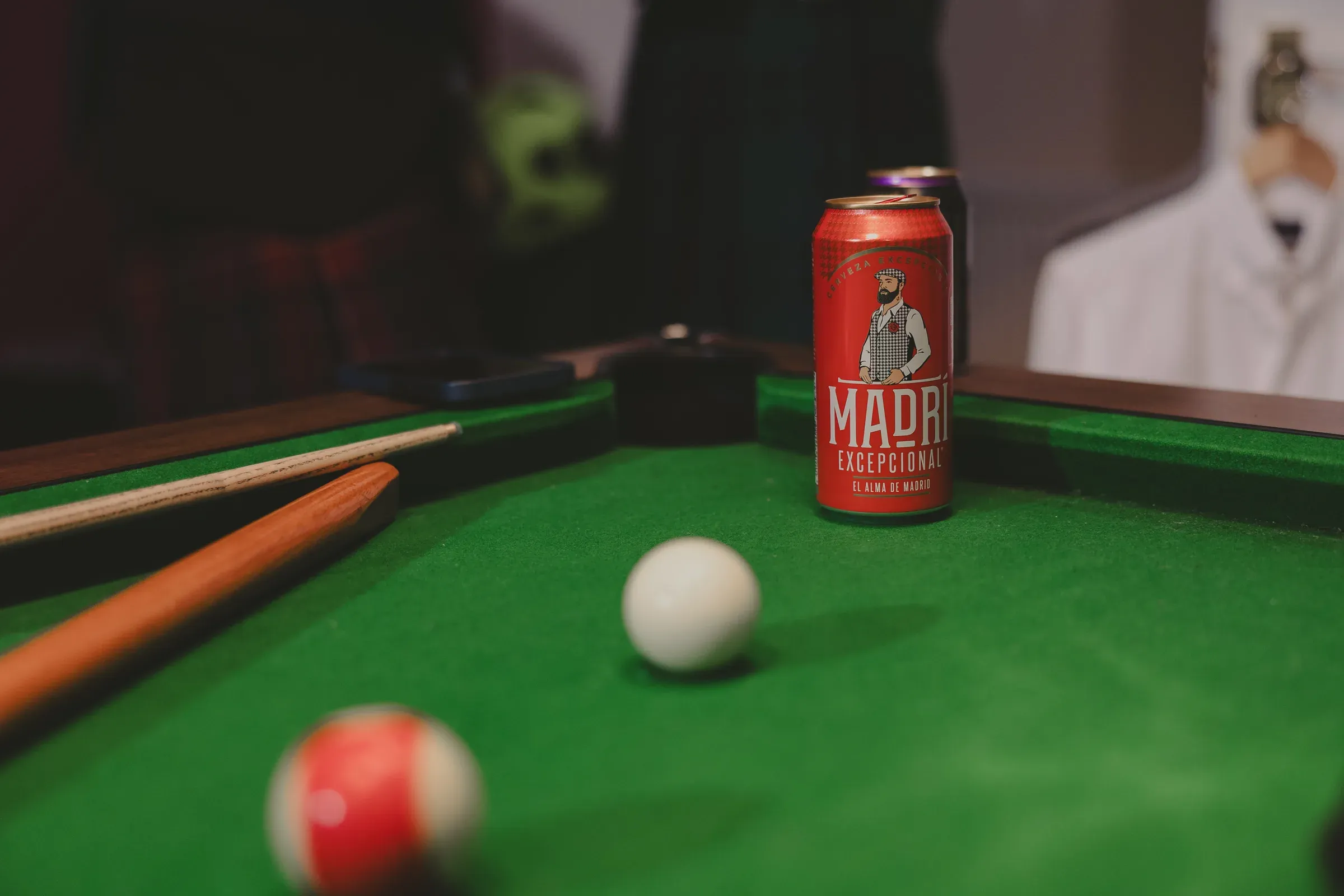 A can of beer resting on a pool table, highlighting the leisure amenities available at the venue.