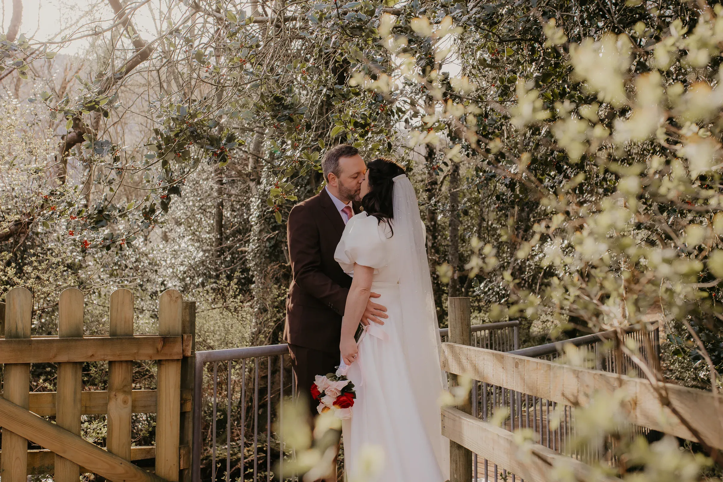 Meg and Ryan share a kiss in the glen surrounded by beautiful scenery near the kirk.