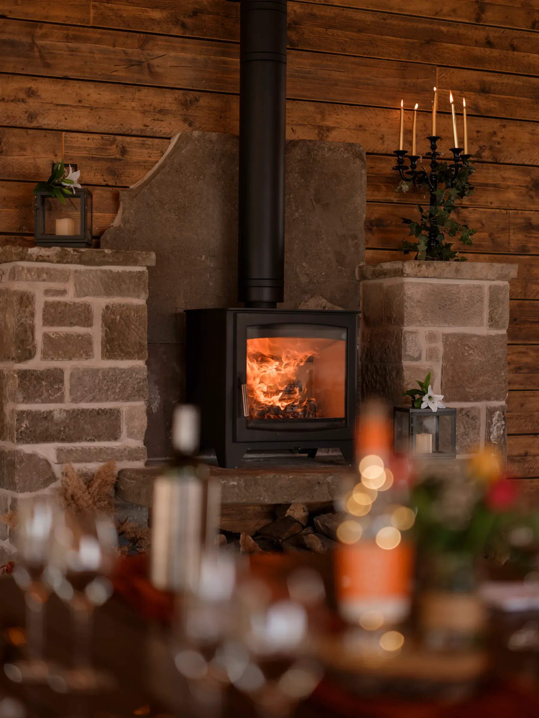 A cosy view of a lit wood-burning stove inside the barn, creating a warm and inviting atmosphere.