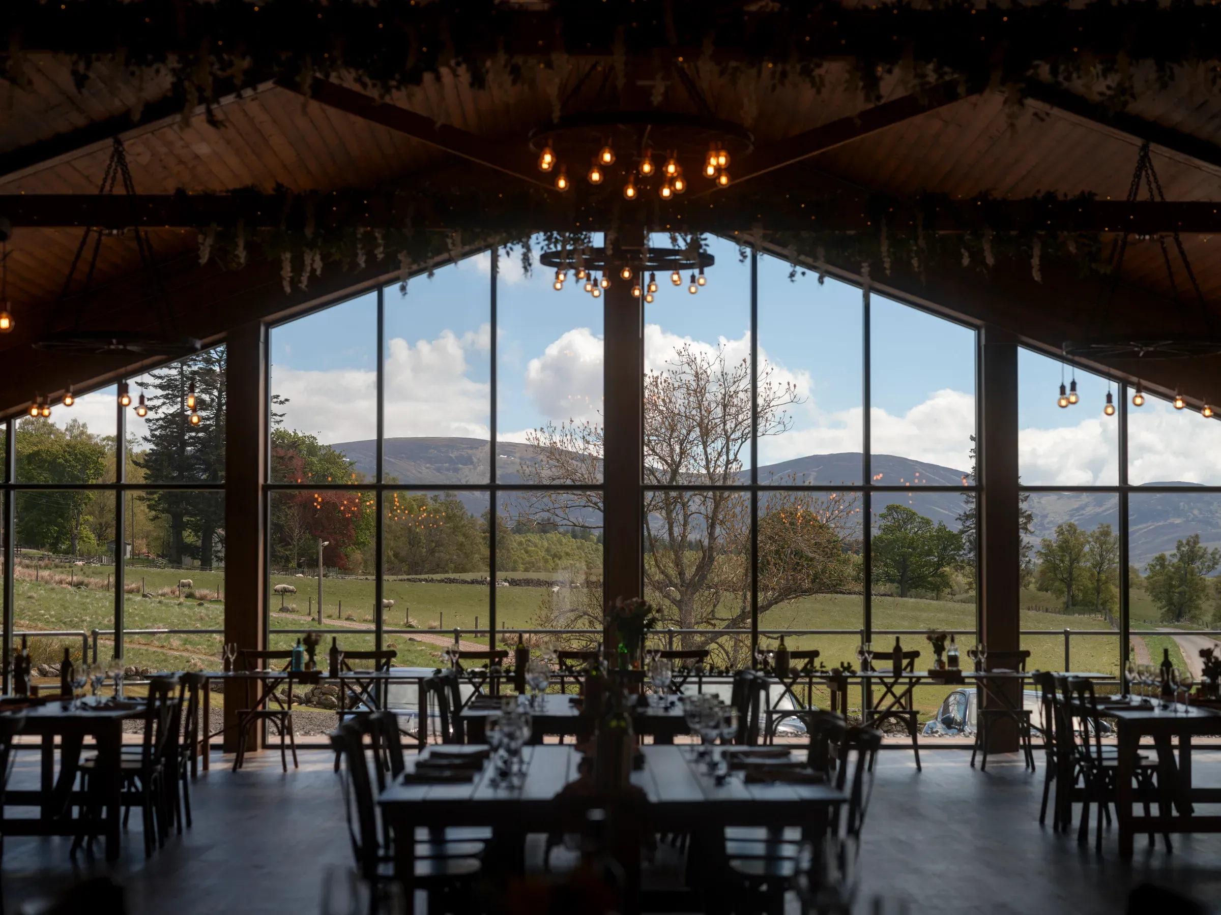 The interior of the barn features a large window showcasing the scenic glen view.