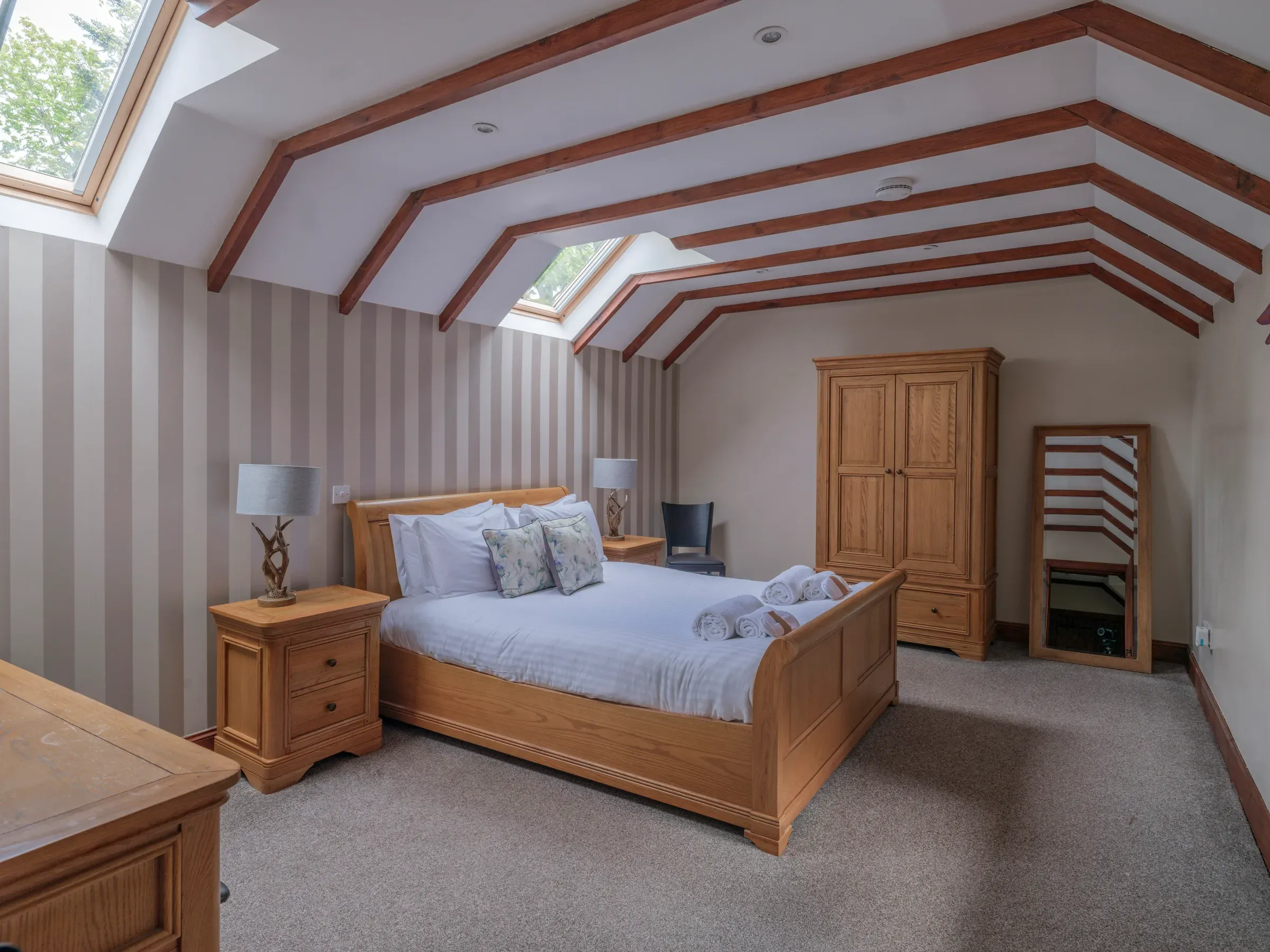 A showcase of the master bedroom interior within the Old Mill Lodge.
