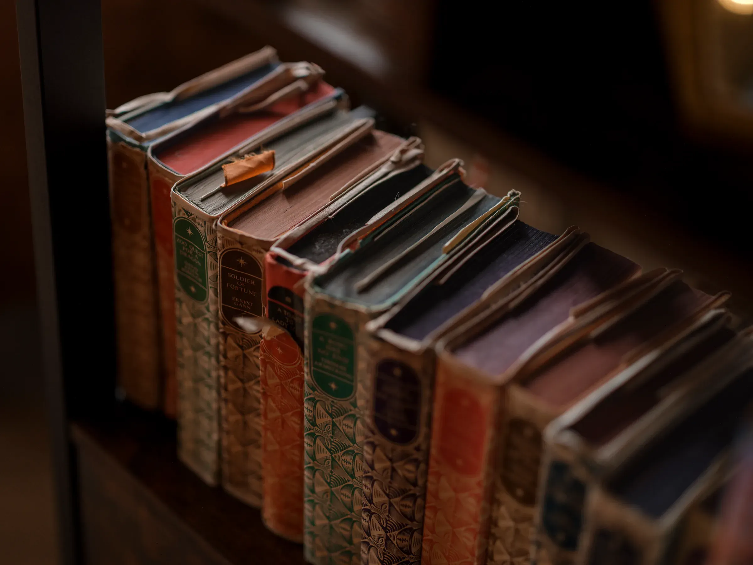 A close-up view of a row of vintage books on a bookshelf, highlighting the venue's history and heritage.