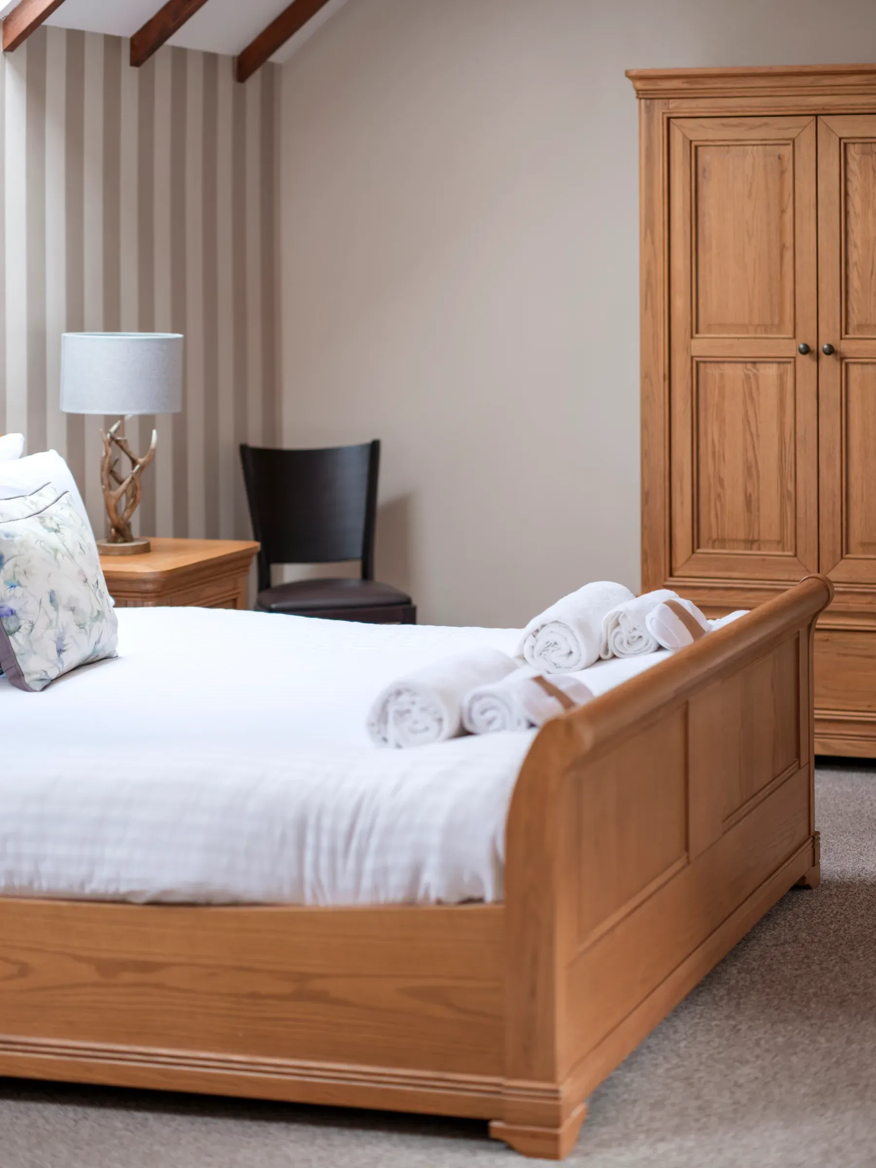 A vertical view of a lodge bedroom interior showcasing the amenities and furnishings.