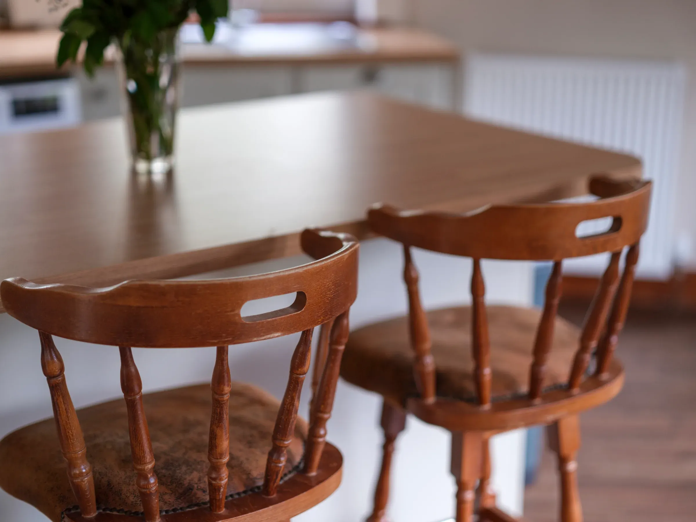 A close-up interior shot of wooden bar stools at a kitchen counter within the lodge.
