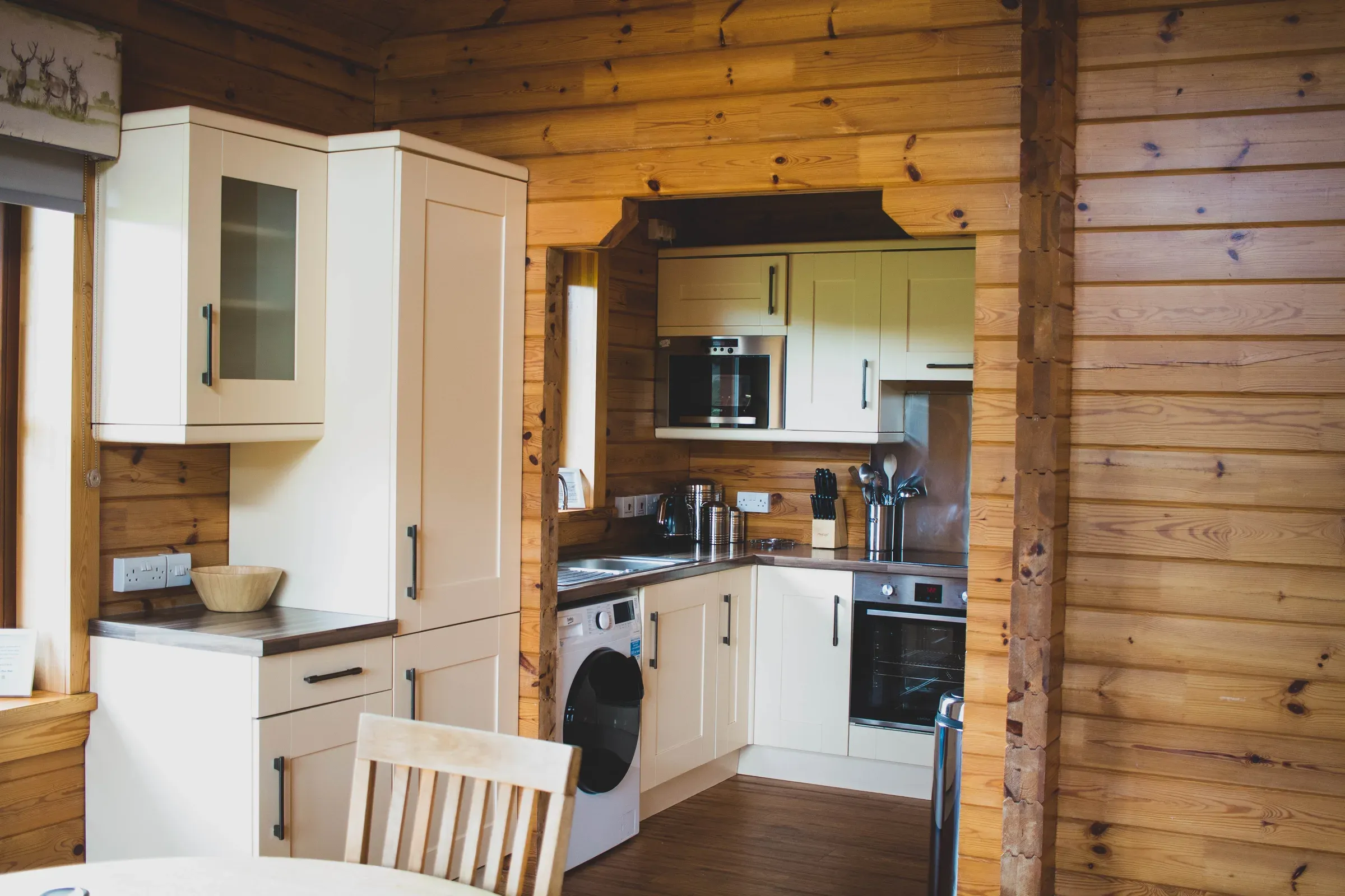 The interior of the Clova Lodge kitchen featuring wooden walls and modern cabinetry.