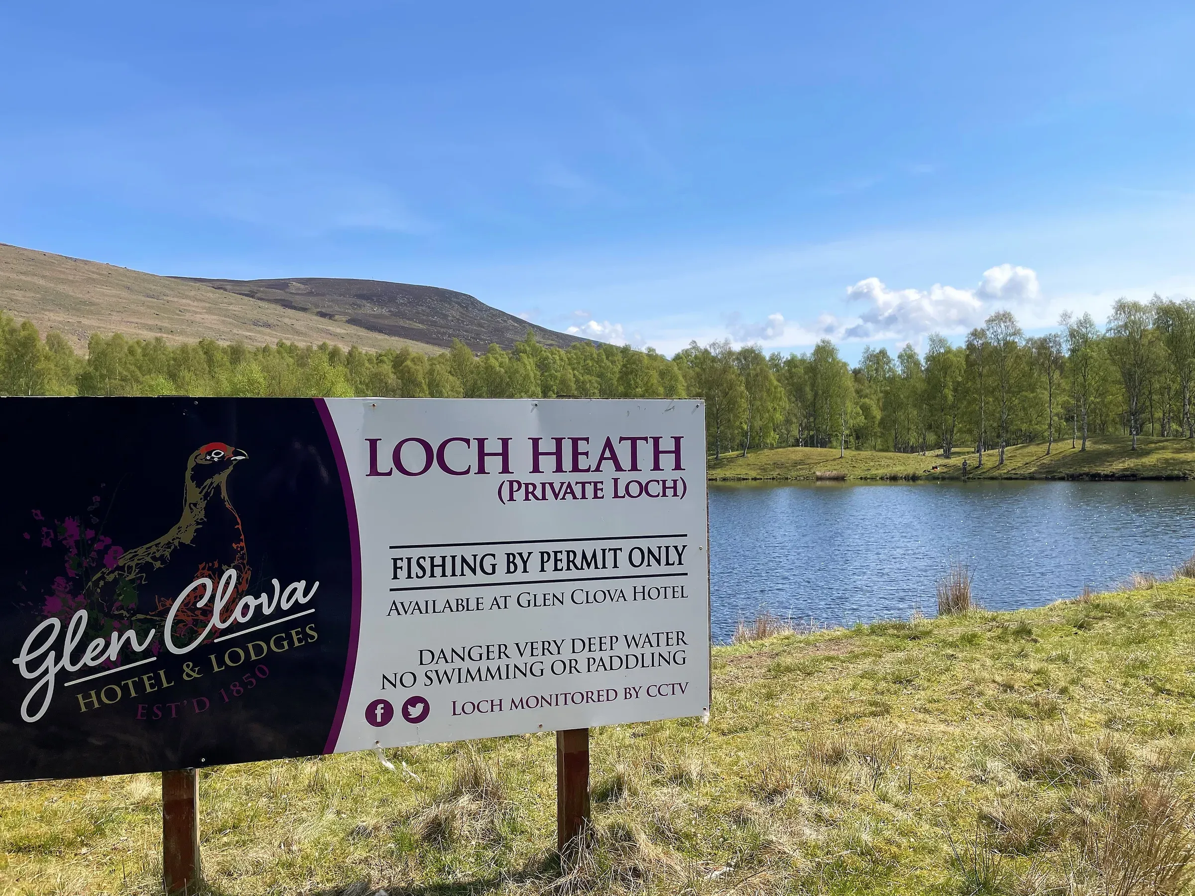 A sign for Loch Heath at Glen Clova Hotel and Lodges overlooking the private loch.