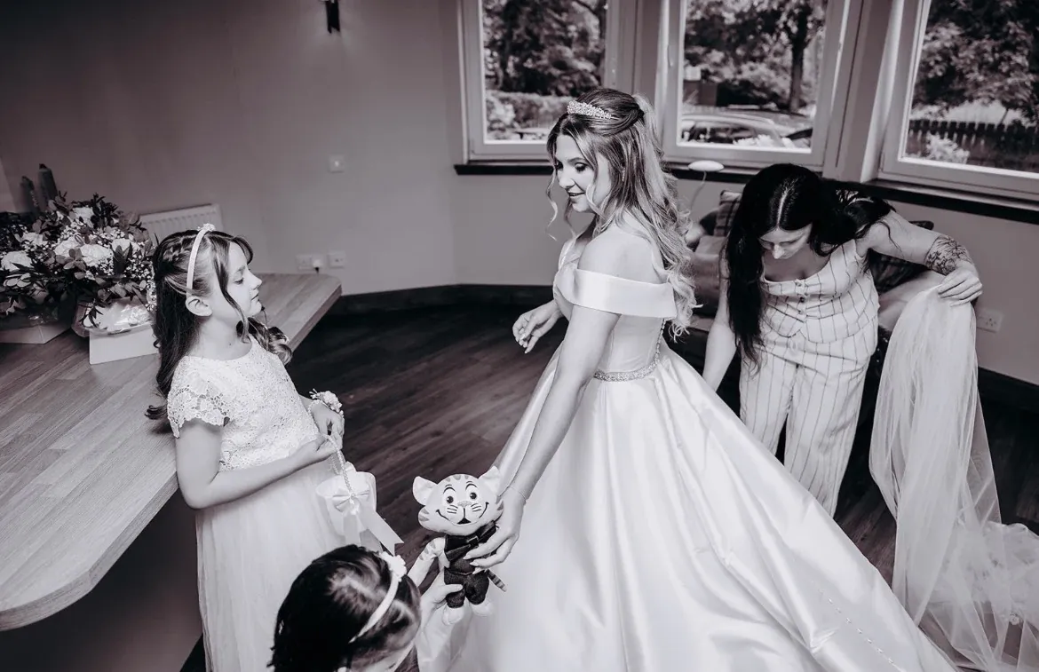 Claire in her wedding dress with the flower girls before the ceremony at Glen Clova