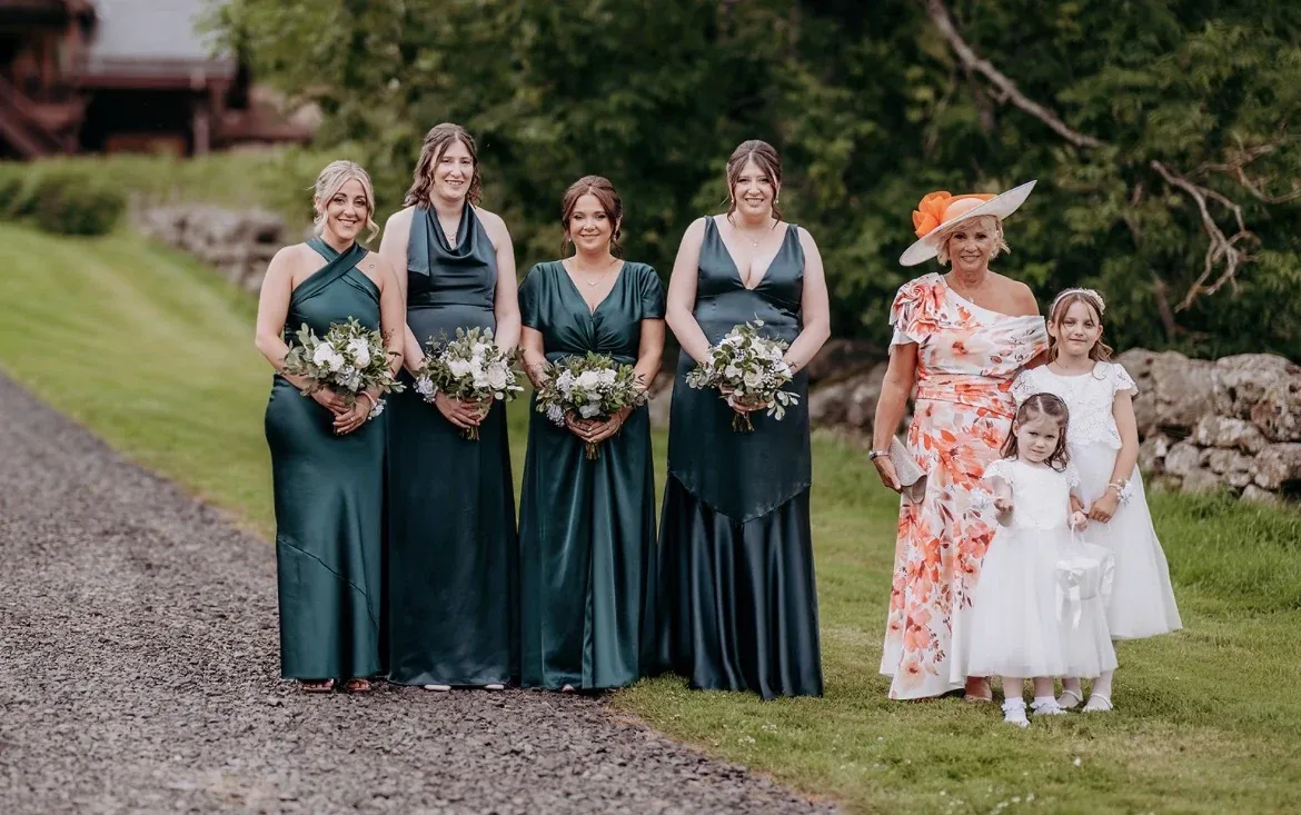 Bridesmaids in green with the flower girls on the path through the glen at Glen Clova